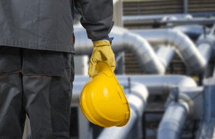 close up of hand holding a hard hat 