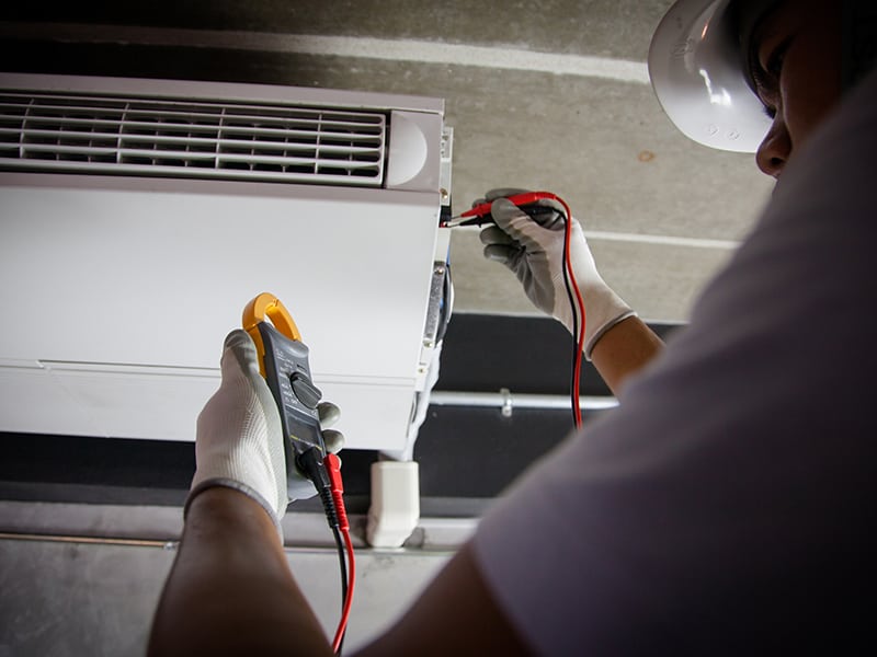 HVAC tech repairing an HVAC unit