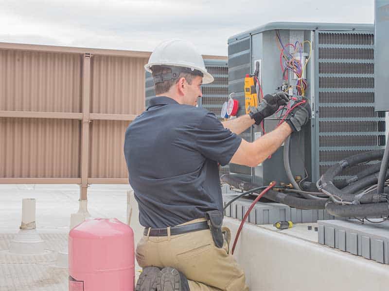 HVAC tech installing a unit