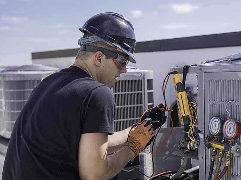 HVAC tech working on a roof top unit