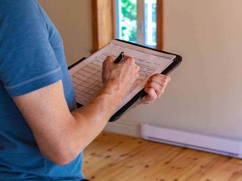 worker writing on a checklist