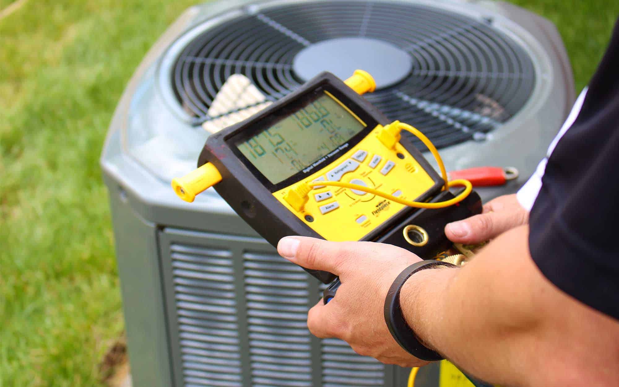 HVAC tech inspecting a residential HVAC unit