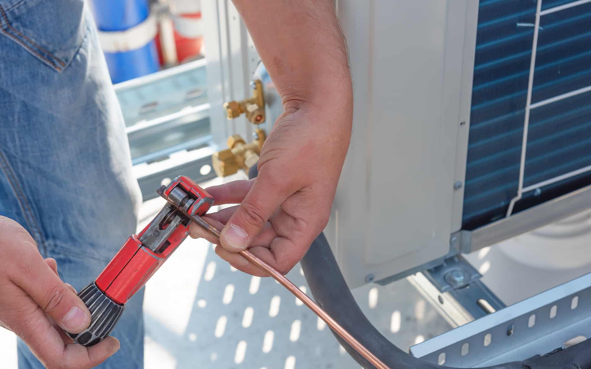 Hvac Tech Working On Units On High Rise Building