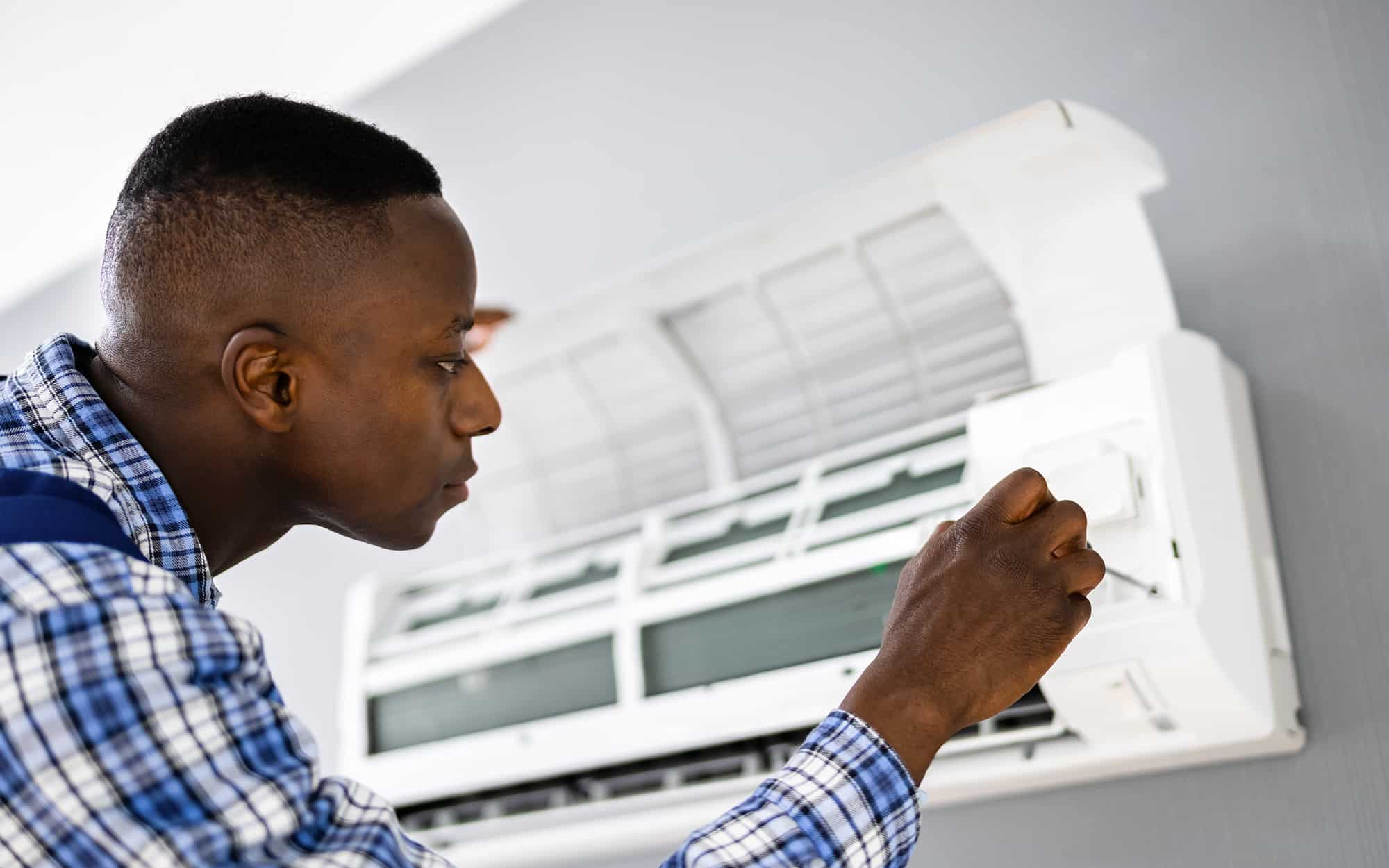 worker installing an AC unit