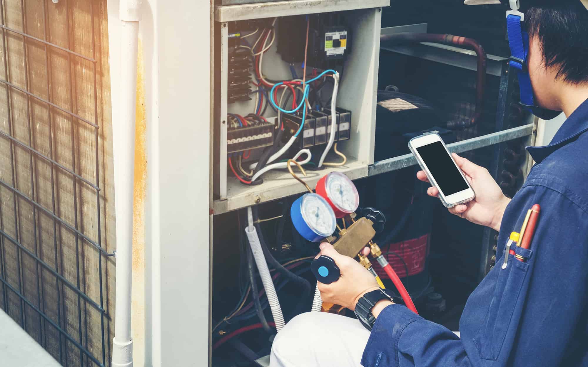 worker testing an AC unit