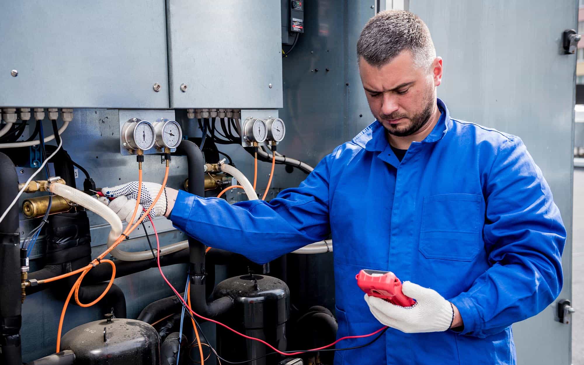 Image Of A Worker Inspecting A Commercial Hvac System.